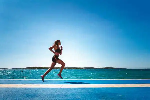 Woman running showing strong leg muscle Staffordshire
